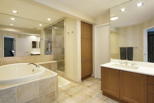 bathroom featuring a bath, a stall shower, recessed lighting, tile patterned flooring, and vanity