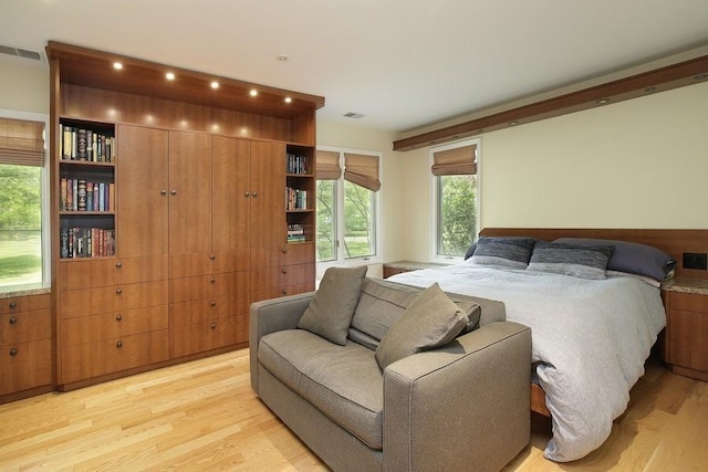 bedroom featuring visible vents and light wood-style floors