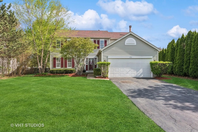 view of front facade featuring an attached garage, driveway, and a front lawn