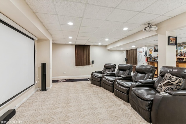 carpeted cinema room with bar, baseboards, recessed lighting, and a paneled ceiling
