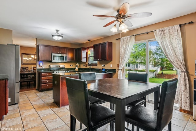 kitchen with stainless steel appliances, dark countertops, and a healthy amount of sunlight
