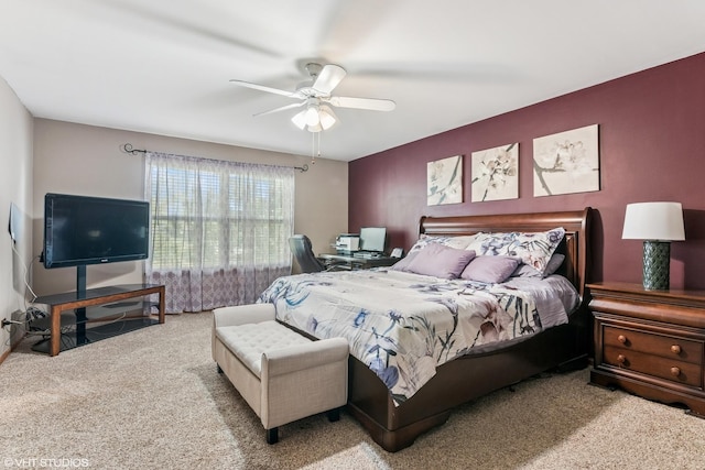bedroom with a ceiling fan and carpet