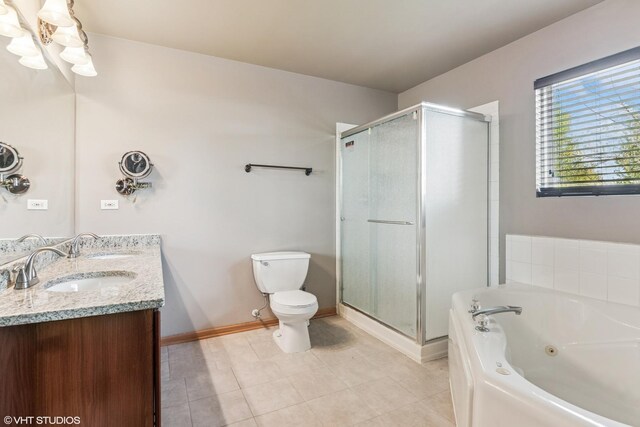 bathroom with double vanity, toilet, tile patterned floors, a whirlpool tub, and a shower stall