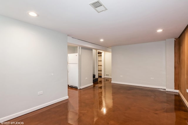 spare room featuring baseboards, finished concrete flooring, and recessed lighting