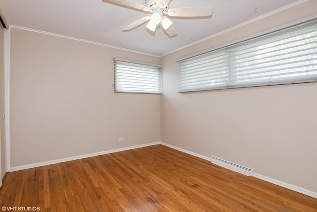 empty room featuring wood finished floors, baseboards, ceiling fan, and crown molding
