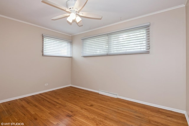 empty room featuring a ceiling fan, light wood-type flooring, baseboards, and ornamental molding