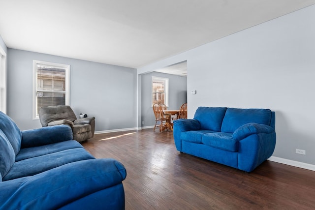 living area featuring baseboards and wood finished floors