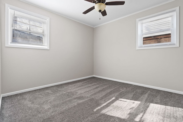 carpeted empty room featuring ceiling fan, baseboards, and ornamental molding
