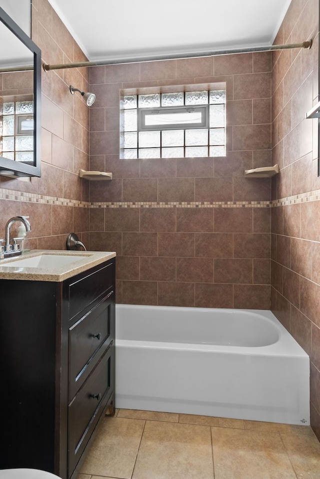 bathroom with tile patterned floors, vanity, tile walls, crown molding, and  shower combination