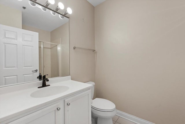 bathroom with vanity, tile patterned flooring, a stall shower, and toilet
