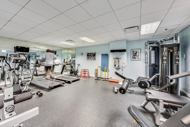workout area with visible vents and a drop ceiling