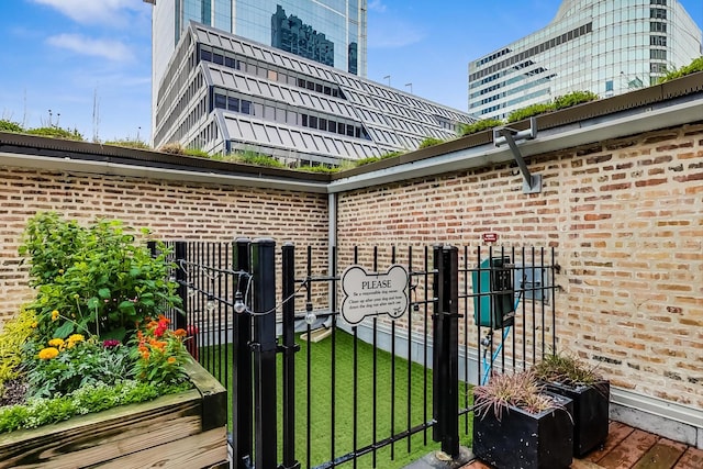view of gate featuring a lawn and fence