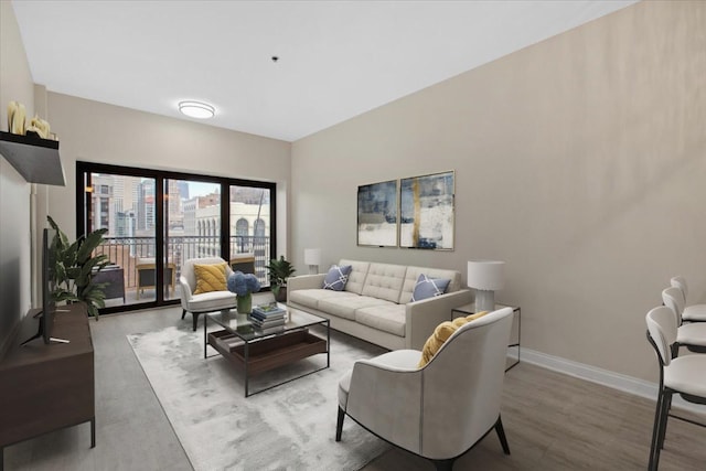 living room featuring baseboards and wood finished floors