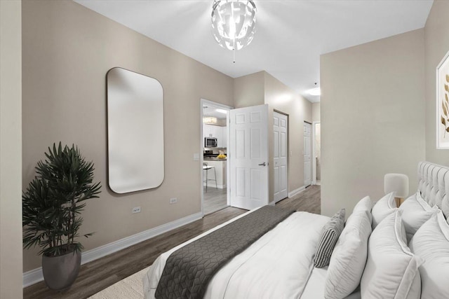 bedroom with baseboards and wood finished floors