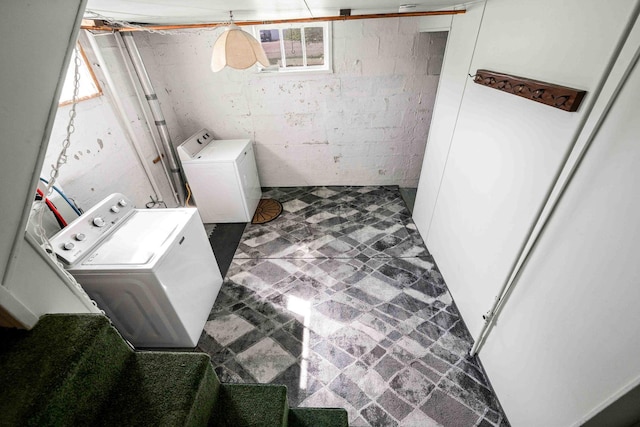 washroom with separate washer and dryer, tile patterned floors, and laundry area