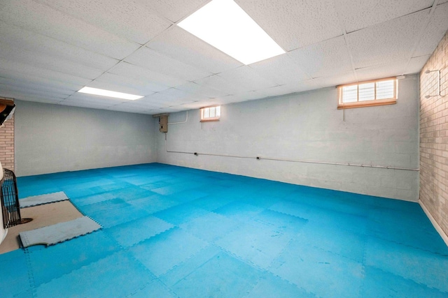 below grade area featuring plenty of natural light and a drop ceiling
