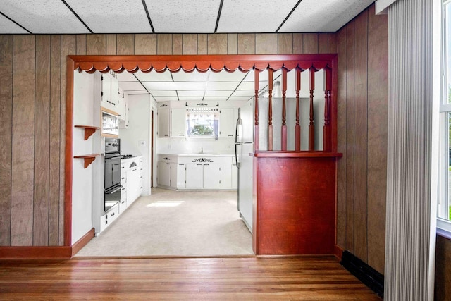 interior space with light wood-style floors and wooden walls