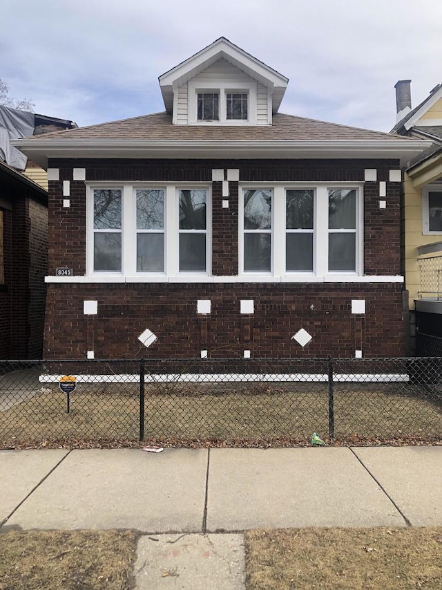 8045 S Escanaba Ave, Chicago, IL 60617 - view of front of property with brick siding, fence private yard, and roof with shingles