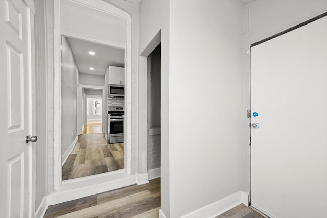 8045 S Escanaba Ave, Chicago, IL 60617 - foyer entrance with baseboards, wood finished floors, and recessed lighting