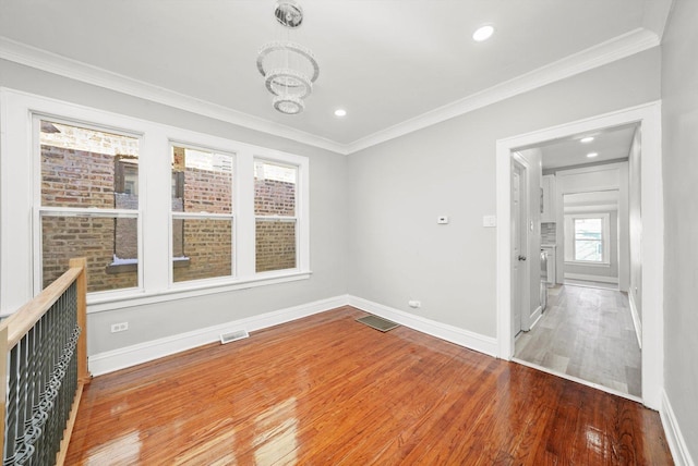 8045 S Escanaba Ave, Chicago, IL 60617 - unfurnished room featuring wood finished floors, visible vents, crown molding, and baseboards