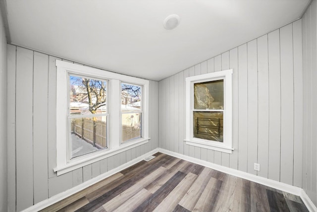 8045 S Escanaba Ave, Chicago, IL 60617 - unfurnished room featuring baseboards, dark wood-type flooring, and visible vents