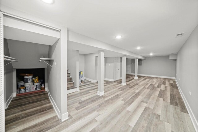 8045 S Escanaba Ave, Chicago, IL 60617 - finished below grade area with visible vents, baseboards, wood finished floors, and stairs