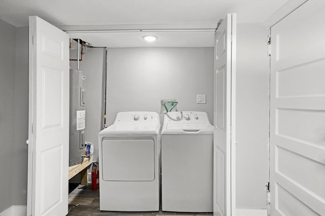 8045 S Escanaba Ave, Chicago, IL 60617 - laundry area featuring dark wood finished floors, electric water heater, laundry area, and washer and clothes dryer