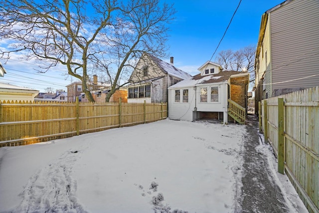 8045 S Escanaba Ave, Chicago, IL 60617 - snowy yard featuring a fenced backyard
