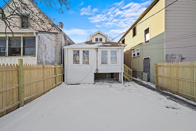 8045 S Escanaba Ave, Chicago, IL 60617 - snow covered rear of property featuring a fenced backyard