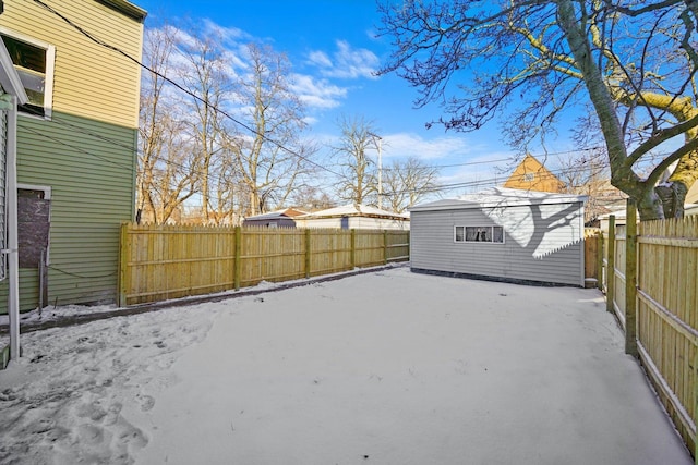 8045 S Escanaba Ave, Chicago, IL 60617 - yard layered in snow featuring a fenced backyard and an outbuilding