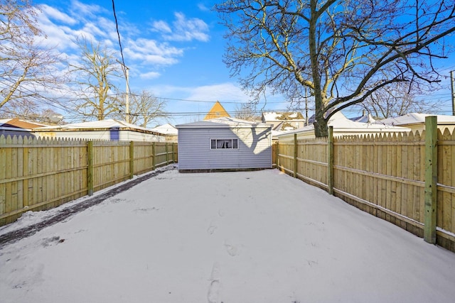 8045 S Escanaba Ave, Chicago, IL 60617 - snowy yard featuring a fenced backyard and an outdoor structure