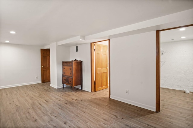 finished basement featuring baseboards, wood finished floors, and recessed lighting