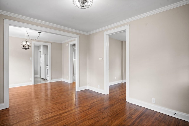 empty room featuring baseboards, wood finished floors, an inviting chandelier, and crown molding