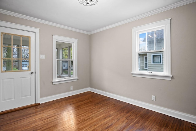 entrance foyer featuring visible vents, wood finished floors, baseboards, and crown molding