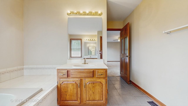 bathroom featuring tile patterned floors, a bath, vanity, and a ceiling fan