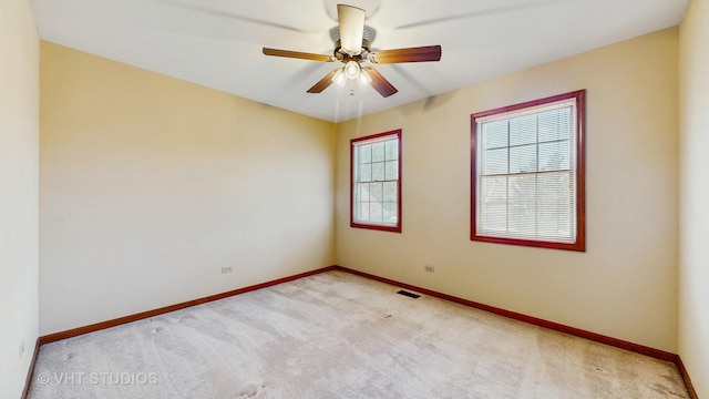 spare room with carpet flooring, baseboards, and a ceiling fan