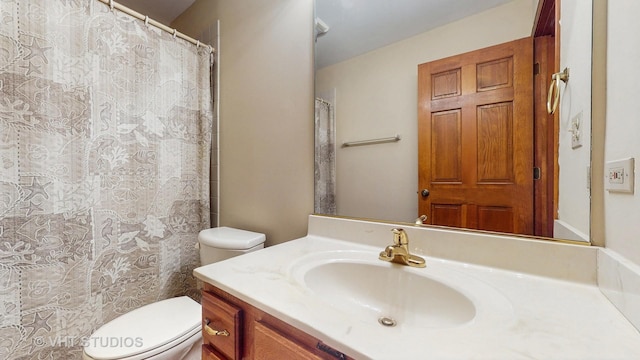 bathroom featuring toilet, vanity, and a shower with shower curtain