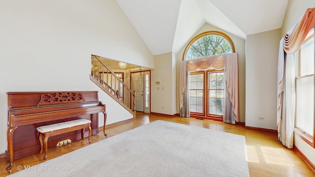 doorway to outside featuring stairway, vaulted ceiling, wood finished floors, and baseboards