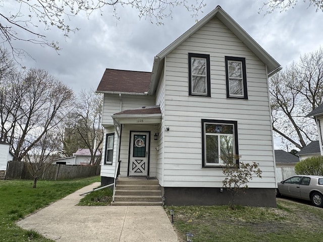 1006 5th Ave, Mendota, IL 61342 - view of front of property with fence, a front lawn, and roof with shingles