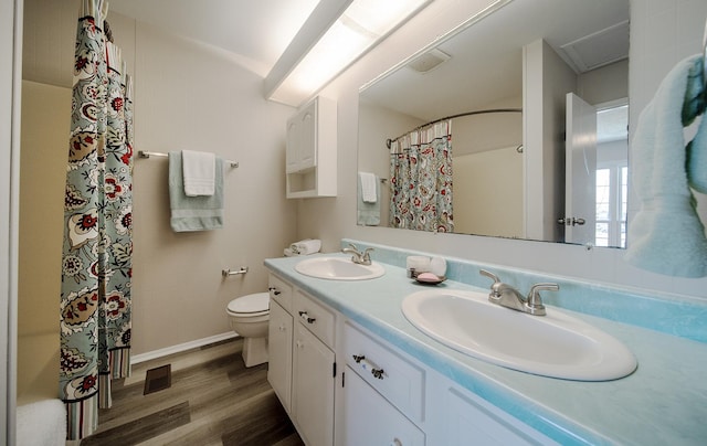 4150 Brentwood Ln, Waukegan, IL 60087 - bathroom with wood finished floors, toilet, double vanity, and a shower with shower curtain