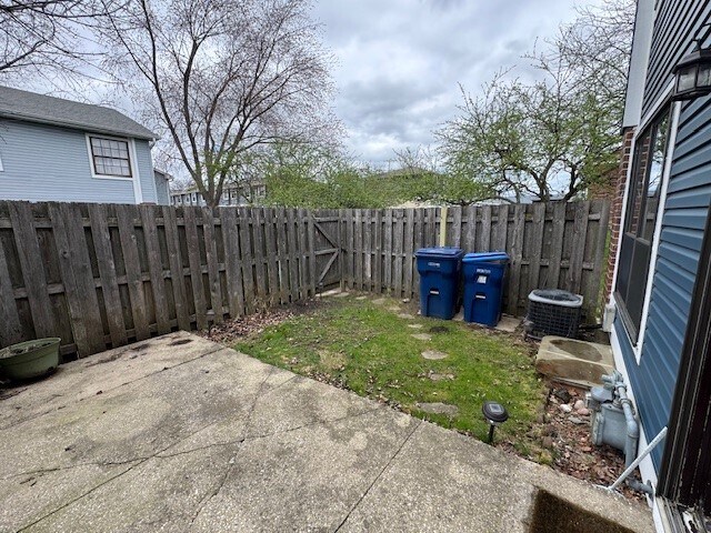 4150 Brentwood Ln, Waukegan, IL 60087 - fenced backyard with a patio area and central AC unit