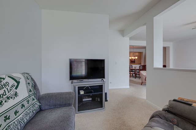 carpeted living room with an inviting chandelier and baseboards