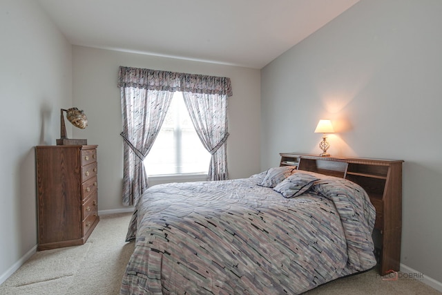 bedroom with carpet floors and baseboards