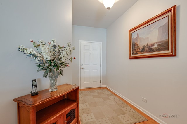 entryway featuring baseboards and light wood-style flooring
