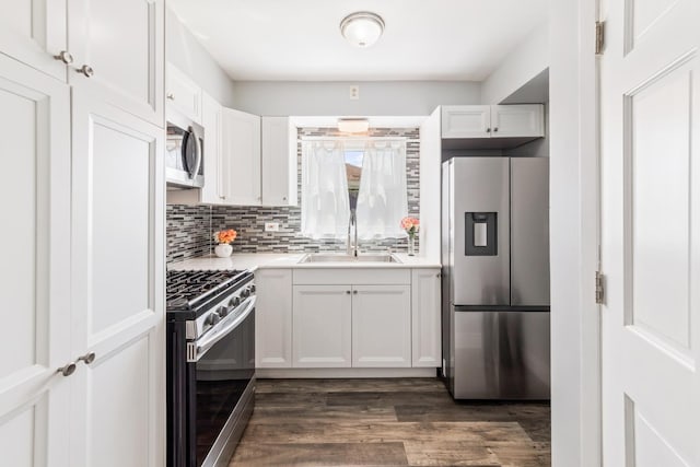 6141 W 35th St, Cicero, IL 60804 - kitchen featuring stainless steel appliances, light countertops, backsplash, dark wood-style flooring, and white cabinetry