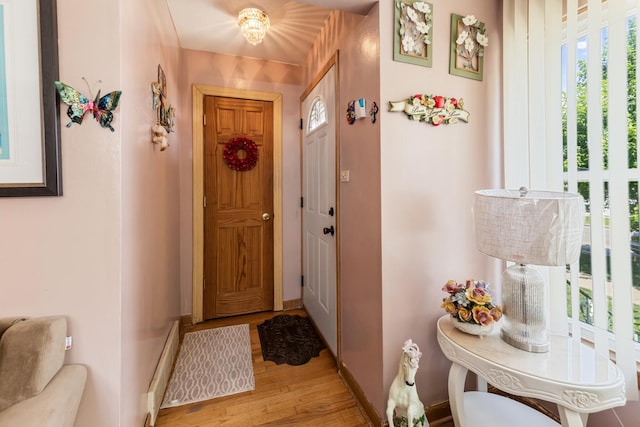 6141 W 35th St, Cicero, IL 60804 - doorway featuring light wood finished floors and a baseboard radiator