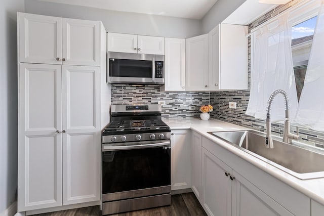 6141 W 35th St, Cicero, IL 60804 - kitchen with appliances with stainless steel finishes, backsplash, white cabinetry, light countertops, and dark wood-type flooring