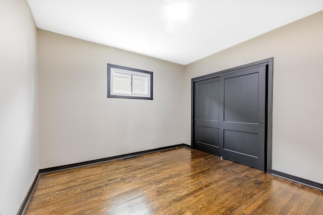 292 W 15th Pl, Chicago Heights, IL 60411 - unfurnished bedroom with baseboards and wood finished floors