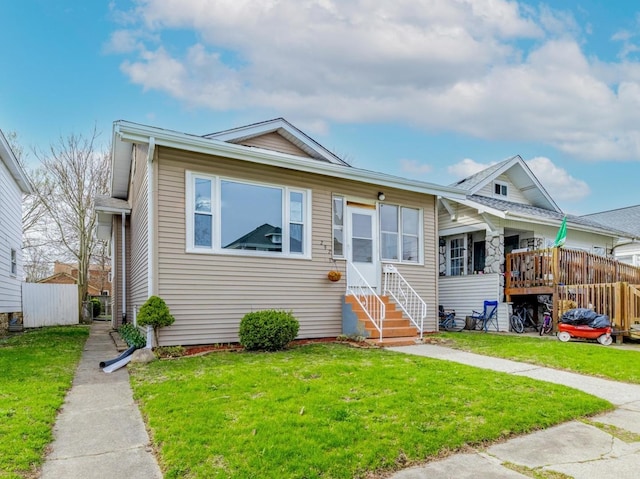 292 W 15th Pl, Chicago Heights, IL 60411 - bungalow with entry steps, fence, and a front yard