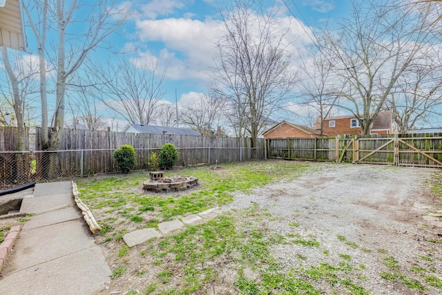292 W 15th Pl, Chicago Heights, IL 60411 - view of yard with a fire pit and a fenced backyard
